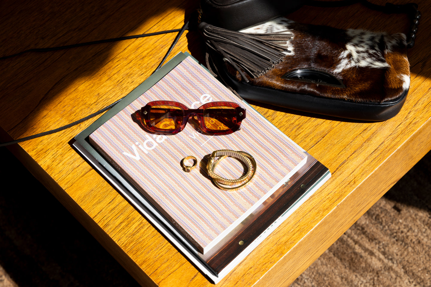 Designer accessories lay in a table setting as an example of pieces you could resell at Encore
